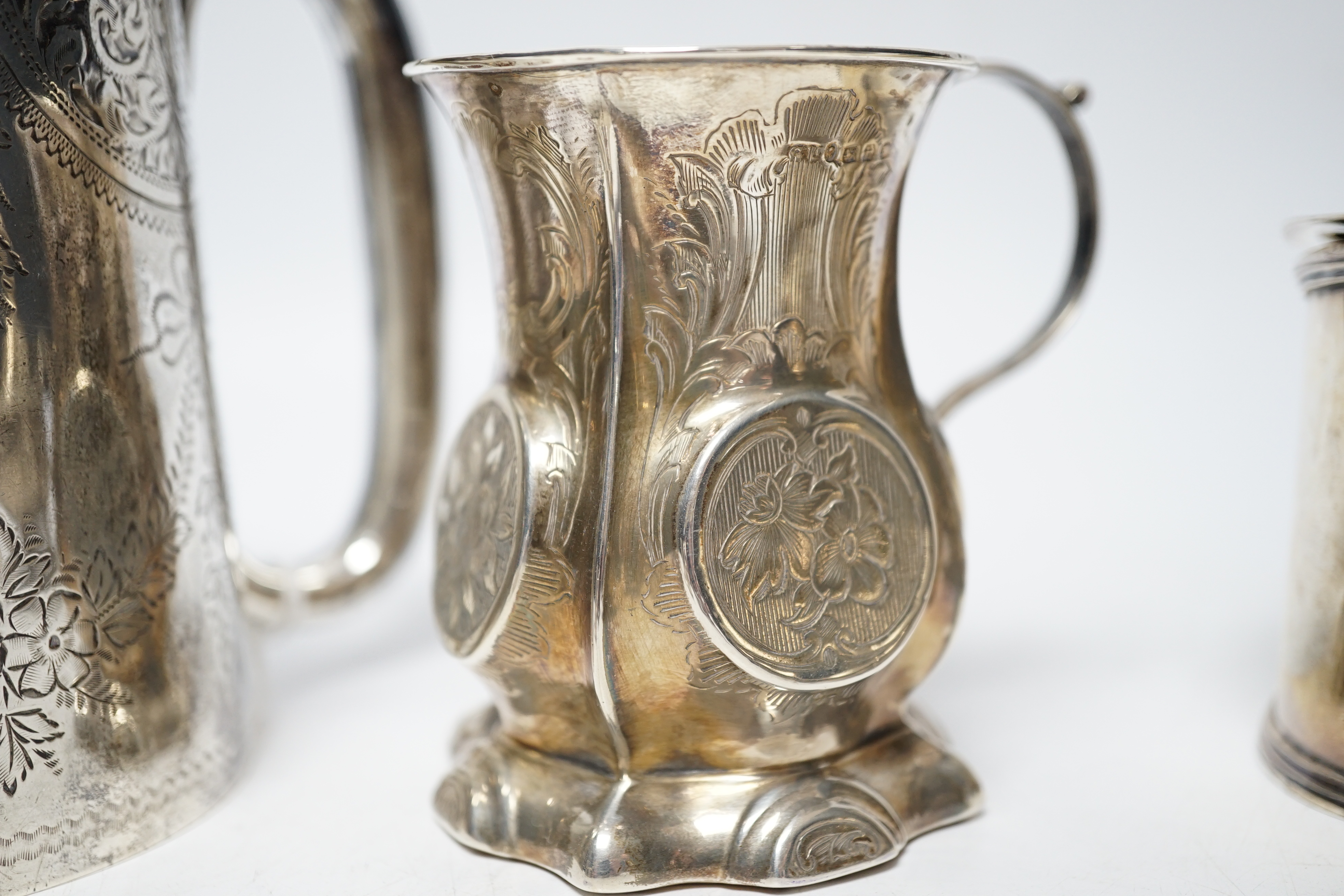 A late Victorian engraved silver mug, Hilliard & Thomason, Birmingham, 1900, 10.2cm, three assorted silver mustard pots including Victorian, a small Victorian silver christening mug and a set of six silver napkin rings,